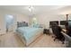 Bright bedroom featuring tile floors, ceiling fan, a comfortable bed, and a functional workspace at 2115 Fowler Secrest Rd, Monroe, NC 28110