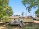 A charming home with a backyard featuring a deck, fenced yard, and mature trees at 2115 Fowler Secrest Rd, Monroe, NC 28110