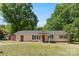 Charming ranch-style home with inviting front porch and mature trees, perfect for serene outdoor living at 2115 Fowler Secrest Rd, Monroe, NC 28110