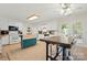 Bright kitchen featuring white cabinets, a center island, and an adjacent dining area for Gathering meals at 2115 Fowler Secrest Rd, Monroe, NC 28110