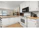 Well-equipped kitchen features white appliances, ample counter space, and bright, white cabinets at 2115 Fowler Secrest Rd, Monroe, NC 28110