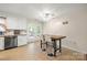 Functional eat-in kitchen area featuring a modern table with bar stool seating near to the french doors to the deck at 2115 Fowler Secrest Rd, Monroe, NC 28110
