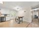 Bright eat-in kitchen features stainless steel appliances, white cabinets, and French doors to outdoor deck at 2115 Fowler Secrest Rd, Monroe, NC 28110