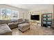 Well-lit living room featuring a comfy sectional sofa, large window, and entertainment center at 2115 Fowler Secrest Rd, Monroe, NC 28110