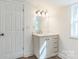 Bright bathroom has a stylish vanity and a well-lit mirror with an ornate vanity light at 221 N Davis Ave, Newton, NC 28658
