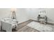 Well-lit bedroom featuring hardwood floors, neutral walls, a desk, and a comfortable armchair at 221 N Davis Ave, Newton, NC 28658