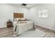 Cozy bedroom showcasing neutral walls, light hardwood floors, and a stylish wicker headboard at 221 N Davis Ave, Newton, NC 28658