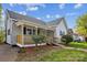 Charming single-story home featuring a covered porch and well-maintained front yard at 221 N Davis Ave, Newton, NC 28658