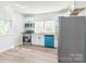 Well-lit kitchen features stainless steel appliances, modern cabinetry, and a window overlooking the yard at 221 N Davis Ave, Newton, NC 28658