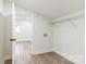 Bright laundry room with washer/dryer hookups, wire shelving, and sleek vinyl flooring offers convenience at 221 N Davis Ave, Newton, NC 28658