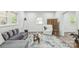 Cozy living room with a grey sofa, white armchair, and decorative rug at 221 N Davis Ave, Newton, NC 28658