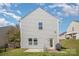 A large backyard featuring a well-maintained lawn and a grill on the patio, great for outdoor enjoyment at 244 Aershire Ct, Concord, NC 28025