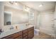 Bright bathroom with double vanity, a large mirror, and shower-tub combo at 244 Aershire Ct, Concord, NC 28025