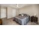 Bedroom with neutral walls, carpet, and a ceiling fan; ample natural light and closet space at 244 Aershire Ct, Concord, NC 28025