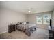 Spacious bedroom with carpet floors, ceiling fan, and large windows at 244 Aershire Ct, Concord, NC 28025