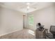 This carpeted bedroom has a ceiling fan, a window providing natural light, and a doorway at 244 Aershire Ct, Concord, NC 28025
