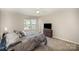 Comfortable carpeted bedroom featuring a ceiling fan and a view of the neighborhood at 244 Aershire Ct, Concord, NC 28025