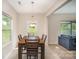 Bright dining room with a view of the backyard, stylish light fixture, and neutral decor at 244 Aershire Ct, Concord, NC 28025