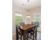 Dining area featuring a dark wood table, seating for four, and lots of natural light at 244 Aershire Ct, Concord, NC 28025