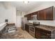Kitchen with stainless steel appliances, spacious sink and countertops, and warm lighting at 244 Aershire Ct, Concord, NC 28025