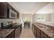Open-concept kitchen featuring stainless appliances, laminate counters, and an adjacent dining area at 244 Aershire Ct, Concord, NC 28025