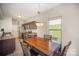 Cozy kitchen with dark wood cabinets, stainless steel appliances, tile floor and eating area at 244 Aershire Ct, Concord, NC 28025