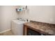 Bright laundry room featuring a washing machine, dryer, and storage solutions, creating an efficient space at 244 Aershire Ct, Concord, NC 28025
