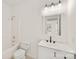 Clean bathroom featuring a white vanity, toilet, and a tub/shower combination with white tile at 2659 Captains Watch Ne Rd, Kannapolis, NC 28083