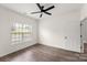 Bedroom featuring a ceiling fan, wood floors and a window offering natural light at 2659 Captains Watch Ne Rd, Kannapolis, NC 28083