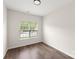 Bedroom with natural light from the window, wood floors, and minimalist design at 2659 Captains Watch Ne Rd, Kannapolis, NC 28083