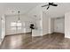 Bright and airy open-concept space with wood-look flooring seamlessly connecting the living and dining areas at 2659 Captains Watch Ne Rd, Kannapolis, NC 28083