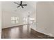 Bright living room featuring wood floors, a ceiling fan, and natural light from windows and glass patio doors at 2659 Captains Watch Ne Rd, Kannapolis, NC 28083