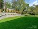 Spacious backyard offers mature trees, tiered landscaping, and manicured lawn at 2909 Hanson Dr, Charlotte, NC 28207