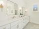 Bright bathroom features dual sinks, marble countertops, gold hardware, and rectangular framed mirrors at 2909 Hanson Dr, Charlotte, NC 28207