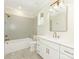 Stylish bathroom with a soaking tub, tiled shower, and a white vanity with gold hardware at 2909 Hanson Dr, Charlotte, NC 28207