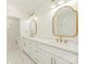 Bathroom with dual sinks, modern mirrors, and gold hardware, brightened by natural light at 2909 Hanson Dr, Charlotte, NC 28207