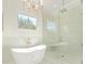 Relaxing bathroom showcasing a standalone tub, elegant chandelier, and glass-enclosed shower at 2909 Hanson Dr, Charlotte, NC 28207