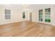 Bright, airy bedroom featuring hardwood floors, a chandelier, and access to the outdoors at 2909 Hanson Dr, Charlotte, NC 28207