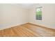 Bright bedroom with hardwood floors and a large window letting in natural light at 2909 Hanson Dr, Charlotte, NC 28207