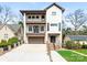 Attractive three-story home with brick accents, a garage, and well-kept landscaping at 2909 Hanson Dr, Charlotte, NC 28207