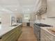 Spacious kitchen with stainless steel appliances, a large island, and coffered ceiling detailing at 2909 Hanson Dr, Charlotte, NC 28207