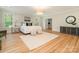 Bright main bedroom with two windows, stylish furnishings, and hardwood floors at 2909 Hanson Dr, Charlotte, NC 28207