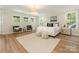 Bright main bedroom with large windows, hardwood floors, and neutral walls at 2909 Hanson Dr, Charlotte, NC 28207