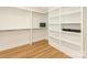 Organized walk-in closet featuring custom shelves, hanging rods, and wood flooring at 2909 Hanson Dr, Charlotte, NC 28207