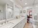Bright bathroom featuring double sinks and a sleek, modern design at 2912 Wheelock Rd, Charlotte, NC 28211