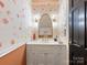 Chic powder room featuring artistic wallpaper, marble countertop and modern fixtures at 2912 Wheelock Rd, Charlotte, NC 28211