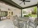Inviting covered patio with stone floor, ceiling fans, comfortable seating, and an outdoor dining area at 2912 Wheelock Rd, Charlotte, NC 28211