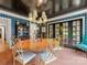 Elegant dining room boasts a unique light fixture, patterned wallpaper, and stylish gold chairs at 2912 Wheelock Rd, Charlotte, NC 28211