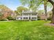 Beautiful two-story home with lush green lawn and mature trees at 2912 Wheelock Rd, Charlotte, NC 28211