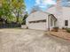 Spacious two-car garage with basketball hoop and a white brick chimney at 2912 Wheelock Rd, Charlotte, NC 28211